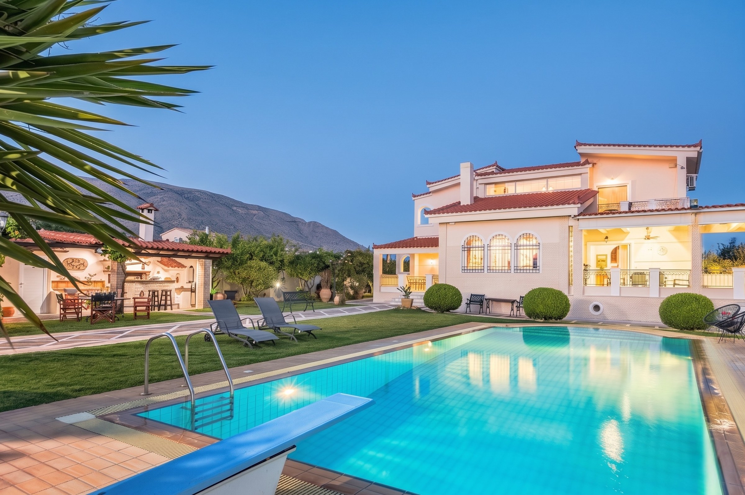 Renko Royal Villa pool and villa exterior at twilight, Athens Riviera